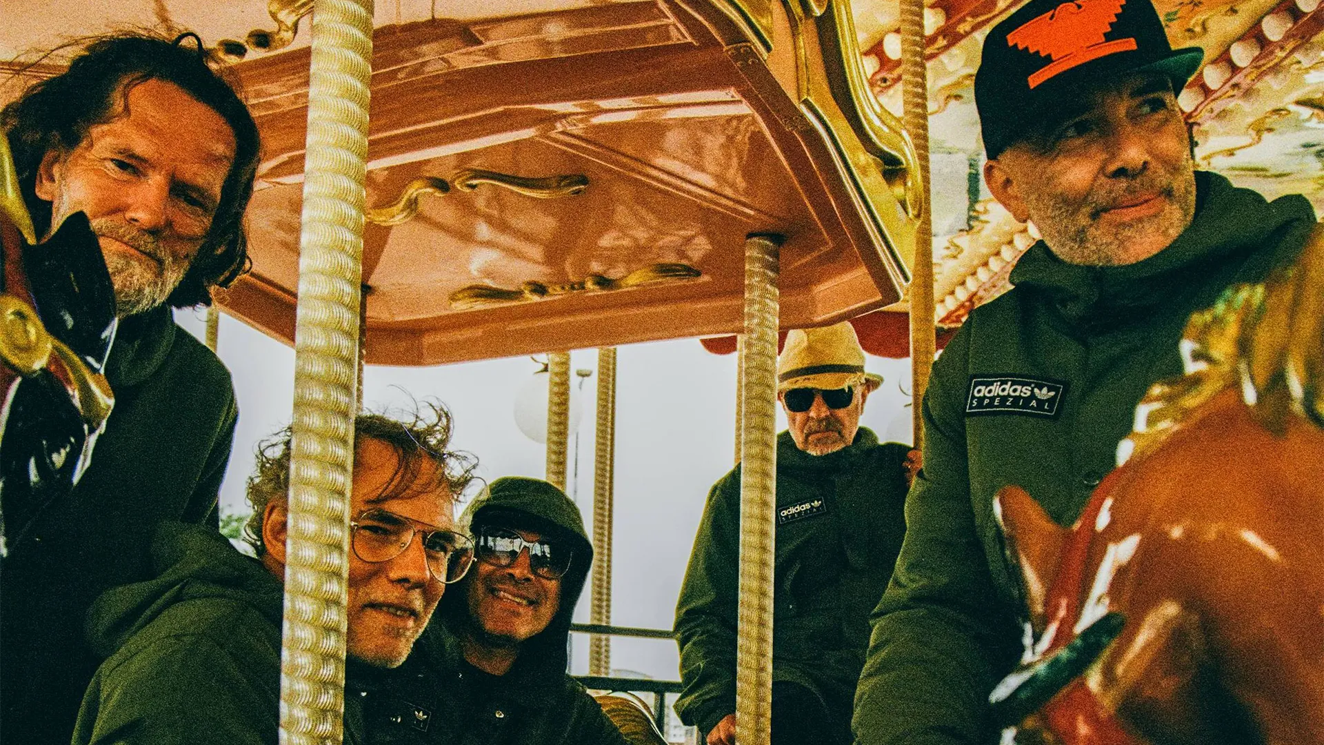 Super Furry Animals on a carousel. From left to right: Bunf, Guto, Gruff, Daf, Cian