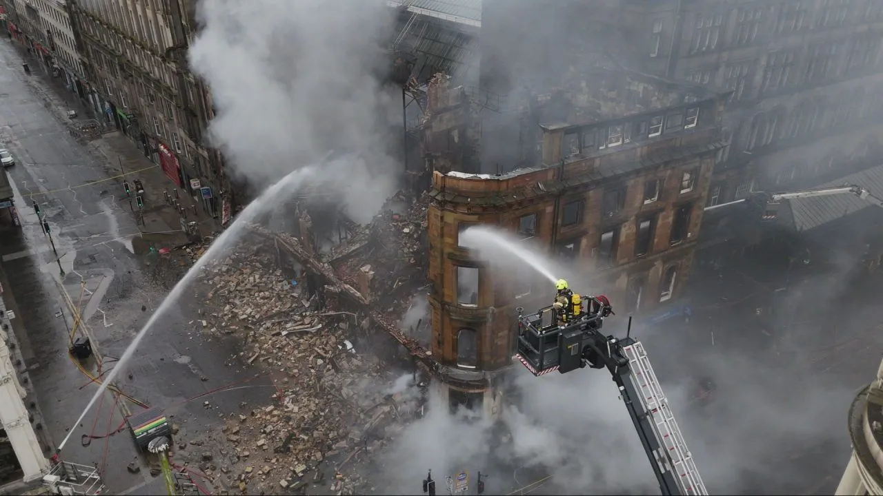 An aerial photograph of water being sprayed on a recent fire by firefighters